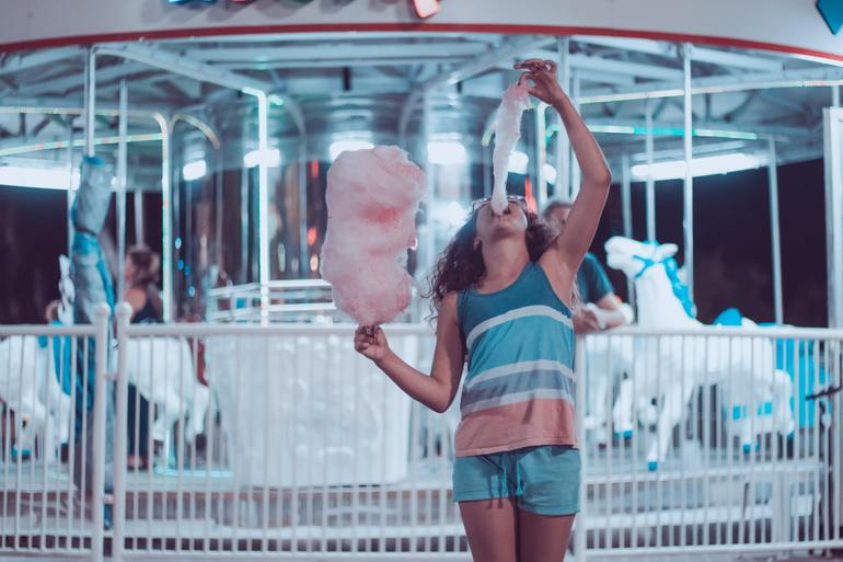 Young girl eating cotton candy