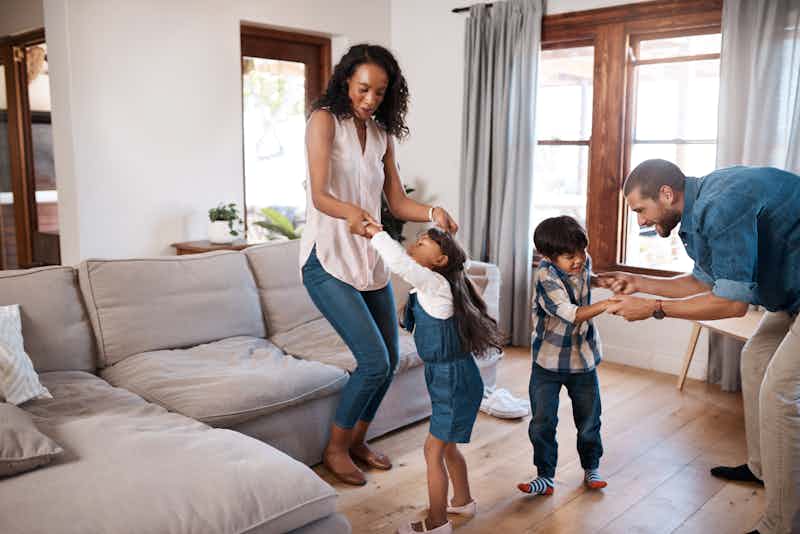 happy family dancing in the house they bought with their class act loan
